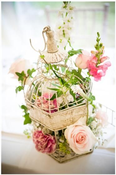 I'm thinking of finding old bird cages and decorate them with flowers and maybe candles/Hanna vintage birdcage with flowers